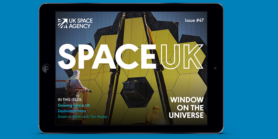The cover of SpaceUK magazine is shown on the screen of an iPad, against a blue background.