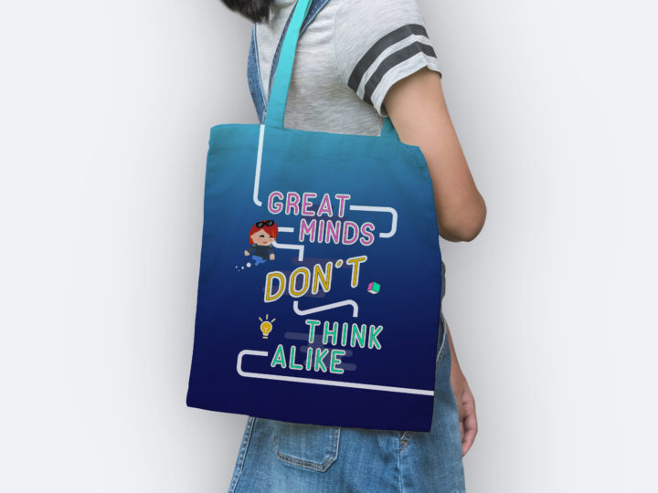 A model with her face cropped is holding a GCHQ tote bag. It says 'great minds don't think alike' and features a character avatar.