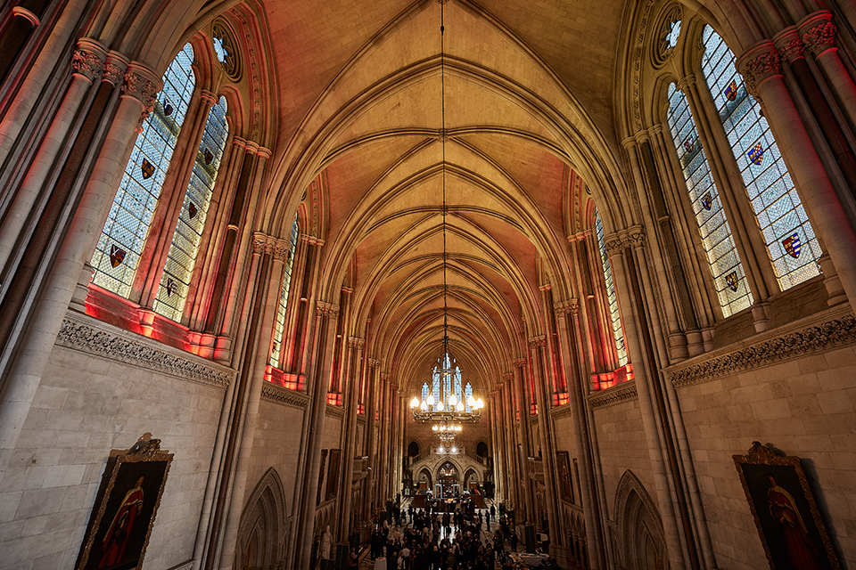 A view of the event with the camera angled upwards to capture the high, arched ceiling.