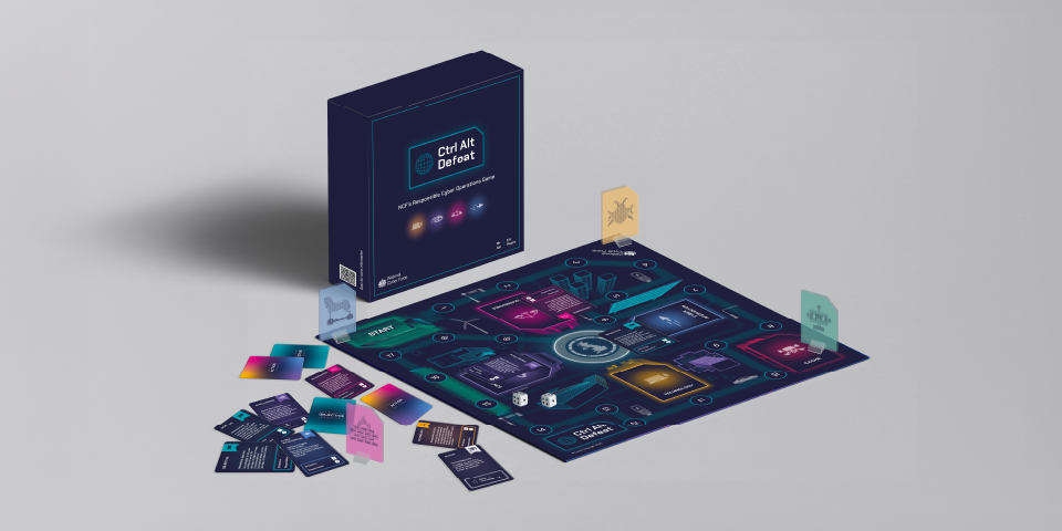 The board game Ctrl Alt Defeat is laid out on a flat surface, showcasing the different aspects that make up the game itself. This includes the box, game board, 134 playing cards, counters and the instructions booklet.