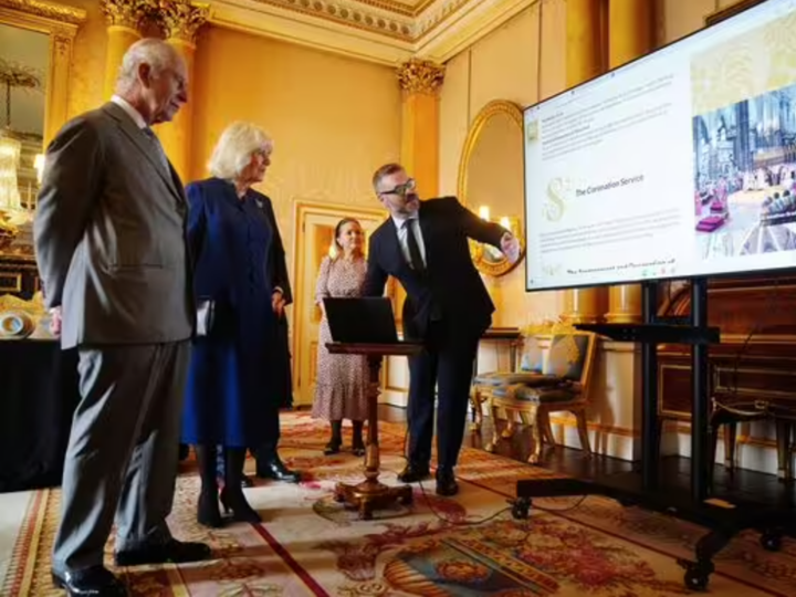 The digital Coronation Roll is presented to His Majesty the King and Her Majesty the Queen on a TV screen